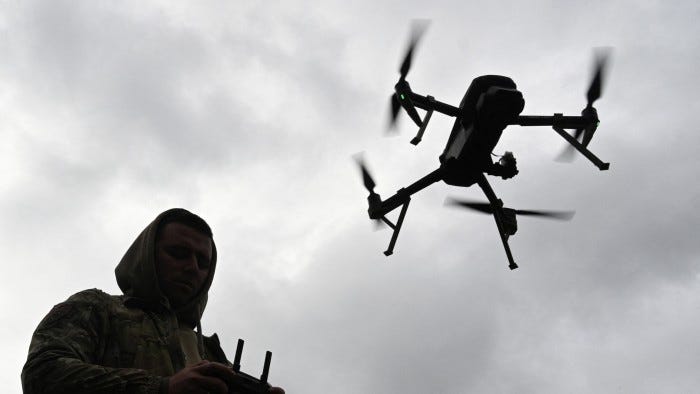 A Ukrainian serviceman operates a drone during a competition that simulates combat conditions