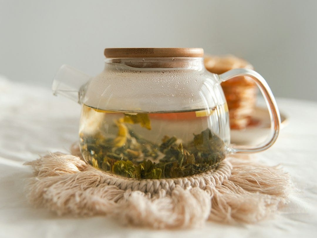 clear glass jar on white textile