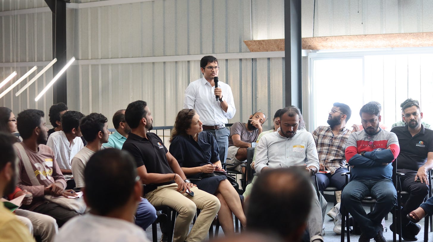 A person speaking into a microphone in front of a group of people