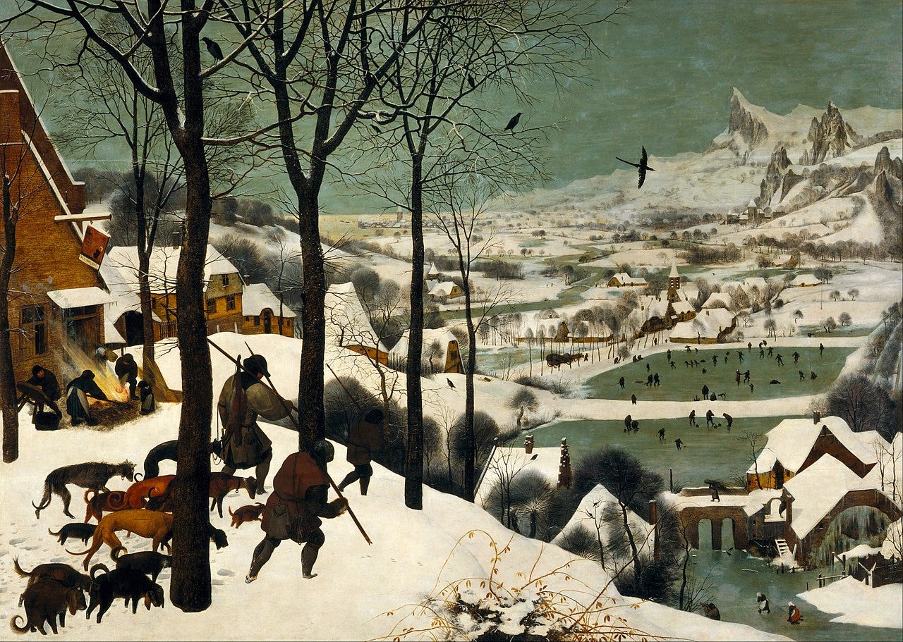 A 16th-century oil painting depicting a vast winter landscape. In the foreground, three hunters with spears and their dogs trudge through deep snow toward a village below. Bare trees frame the scene, while in the distance, tiny figures ice-skate on a frozen river. The sky is a muted gray, and distant peaks loom beyond, adding depth and scale to the cold, atmospheric setting.