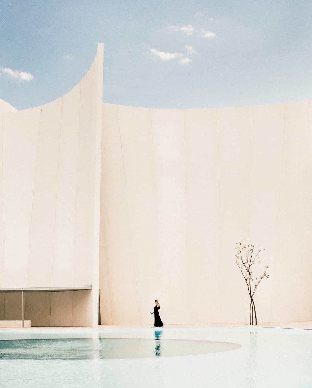 woman standing in front of white building