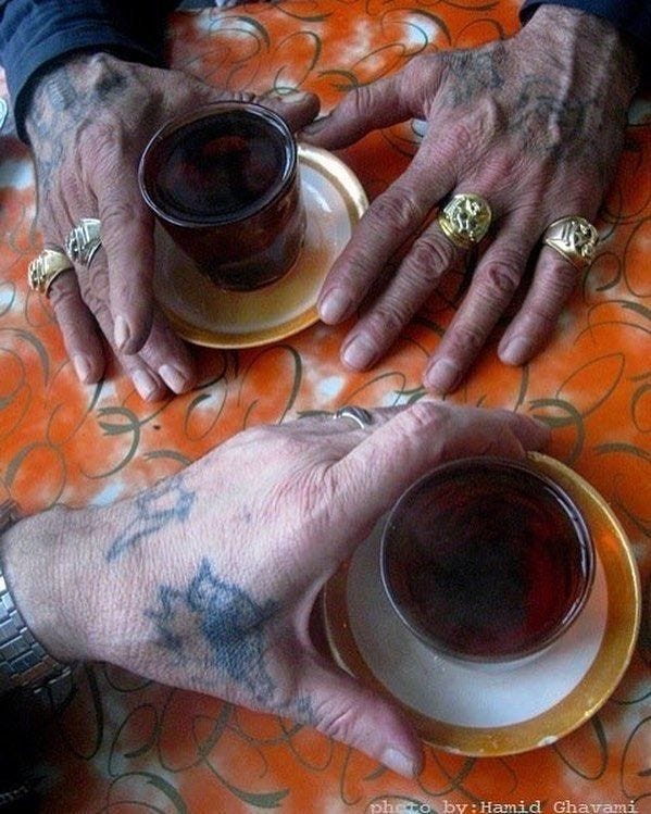 This may contain: two people holding cups and saucers with their hands