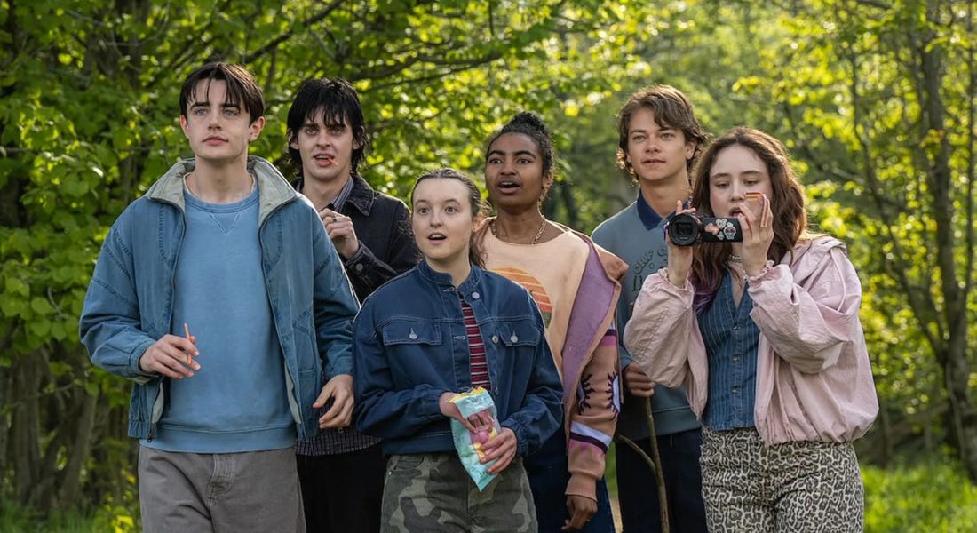 A group of people standing in the woods looking surprised A group of people standing in the woods looking surprised