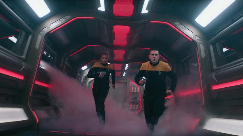 This image shows two Starfleet security officers running down the corridor of the U.S.S. Stargazer in the opening moments of _Star Trek: Picard's_ Season 2 premiere episode ("The Star Gazer"). The ship is at red alert and steam blows through the corridor, signifying that the Stargazer is under attack. This image shows two Starfleet security officers running down the corridor of the U.S.S. Stargazer in the opening moments of _Star Trek: Picard's_ Season 2 premiere episode ("The Star Gazer"). The ship is at red alert and steam blows through the corridor, signifying that the Stargazer is under attack.