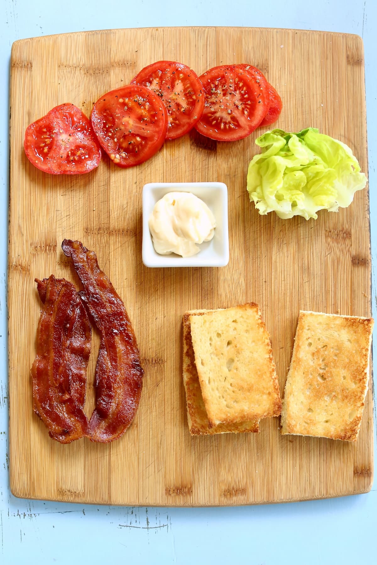 an overhead photo of ingredients needed for a classic clubhouse sandwich.