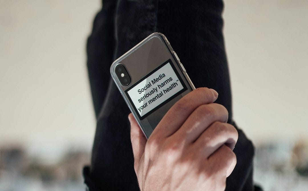 person holding black iphone 4