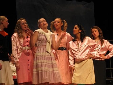 photos of Dr. Kiki in highschool acting as Marty in Grease.