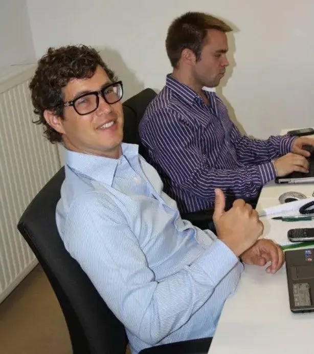 Marc Alexander Christ and I sitting and working at desk in front of our laptops in Groupon Office in Belgium