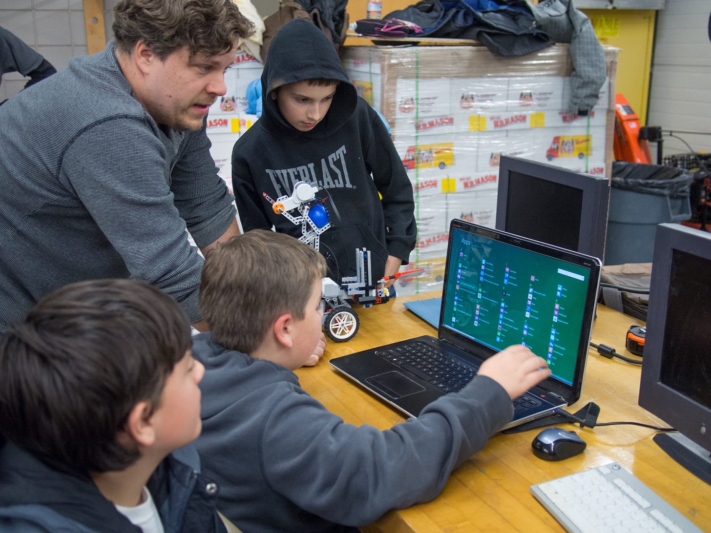 gathered around a laptop computer