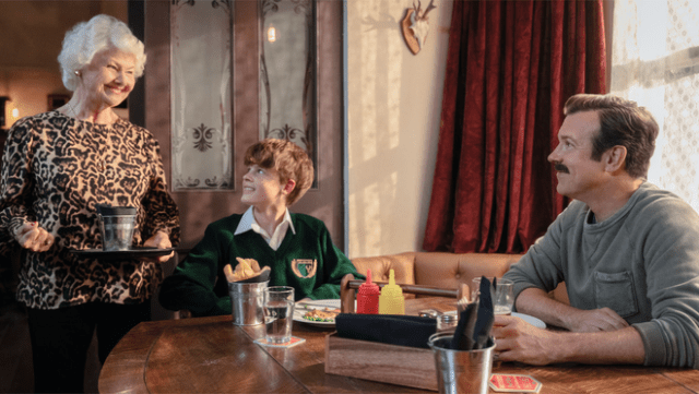 Annette Badland, Grant Feely and Jason Sudeikis in “Ted Lasso” season four, premiering summer 2026 on Apple TV.