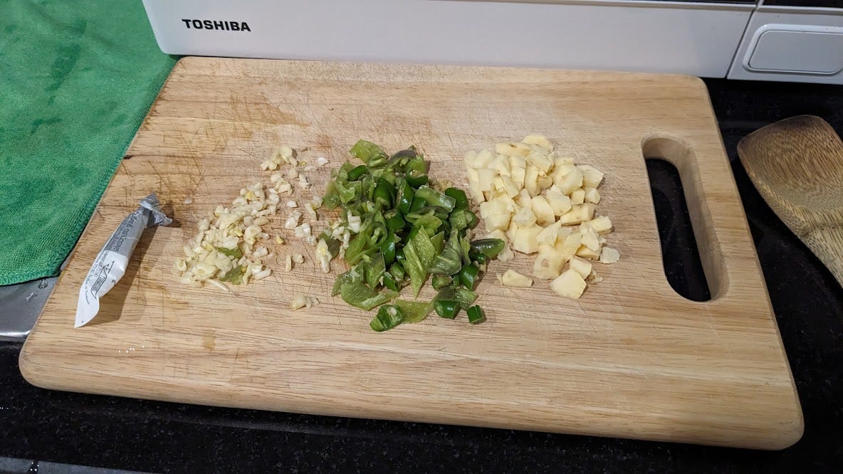 garlic, chiles and ginger on a cutting board