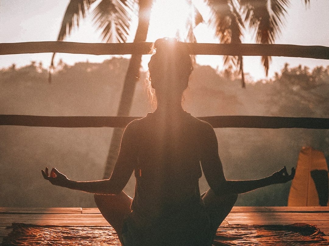 woman doing yoga meditation on brown parquet flooring woman doing yoga meditation on brown parquet flooring