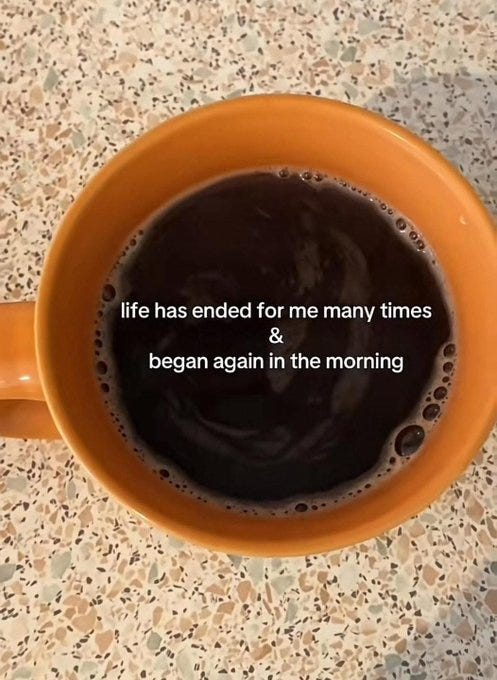 An orange mug filled with dark coffee, placed on a speckled countertop. White text overlay reads "life has ended for me many times & began again in the morning."