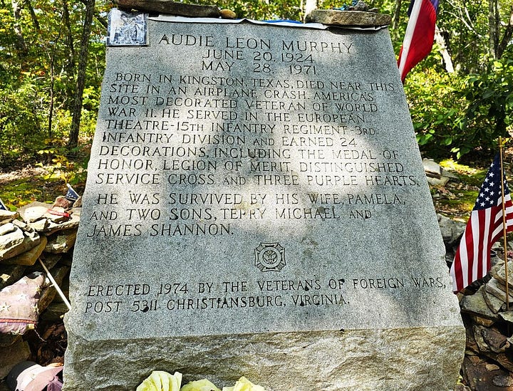 Stone monument and view of mountains.