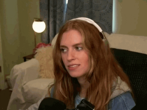 Curious woman with headphones and ‘Intrigue’ caption – GIF used in investment deep dive on KB Financial to tease undervalued bank thesis with high ROE.