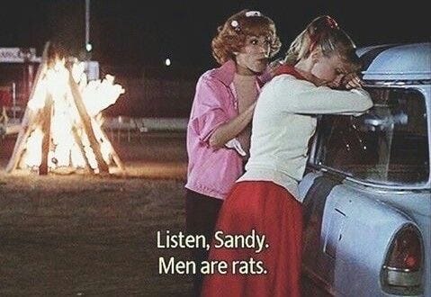 This may contain: two women leaning against the back of a car with an ad on it that says, listen, sandy men are rats