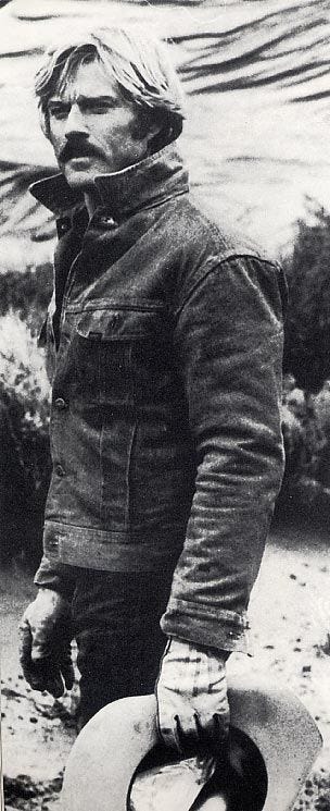 This may contain: black and white photograph of a man with a hat on his head standing in the sand This may contain: black and white photograph of a man with a hat on his head standing in the sand