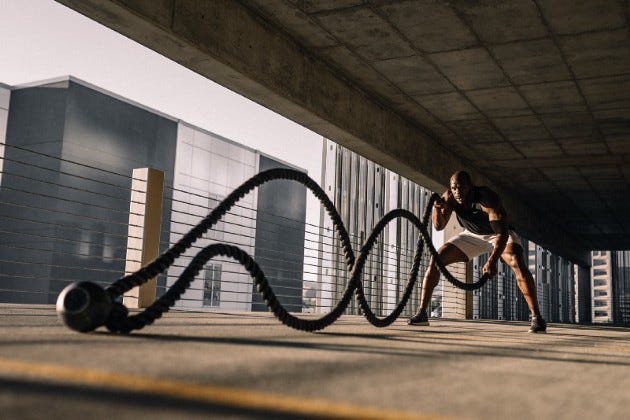 A man working out with rope.