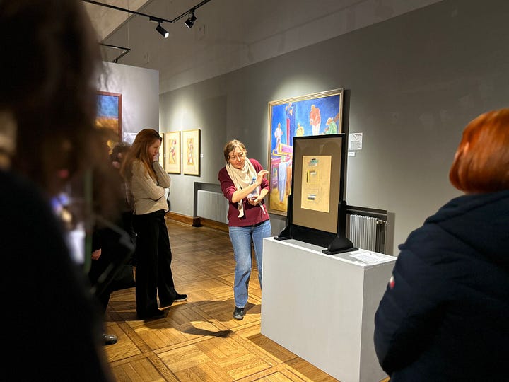 Visitors view artworks at a museum exhibition in Lviv.