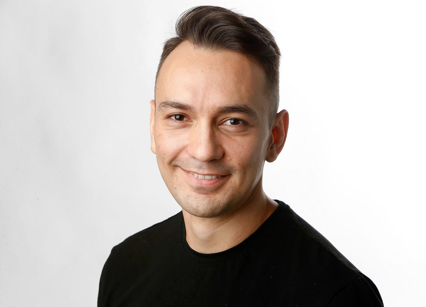 A headshot of freelancing expert Tim Herrera against a white background