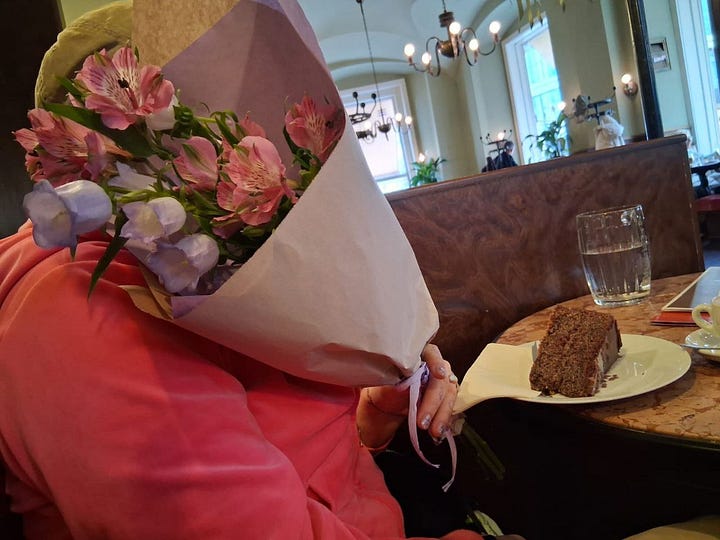 Me in a cafe with a cake in pink sweater, hiding behind pink flowers. And me and my friend standing in front of a giant zombie, pretending to scream.