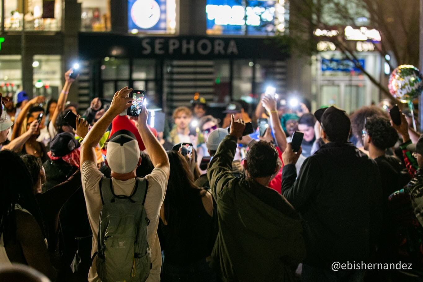 May be an image of 5 people, street, crowd and text