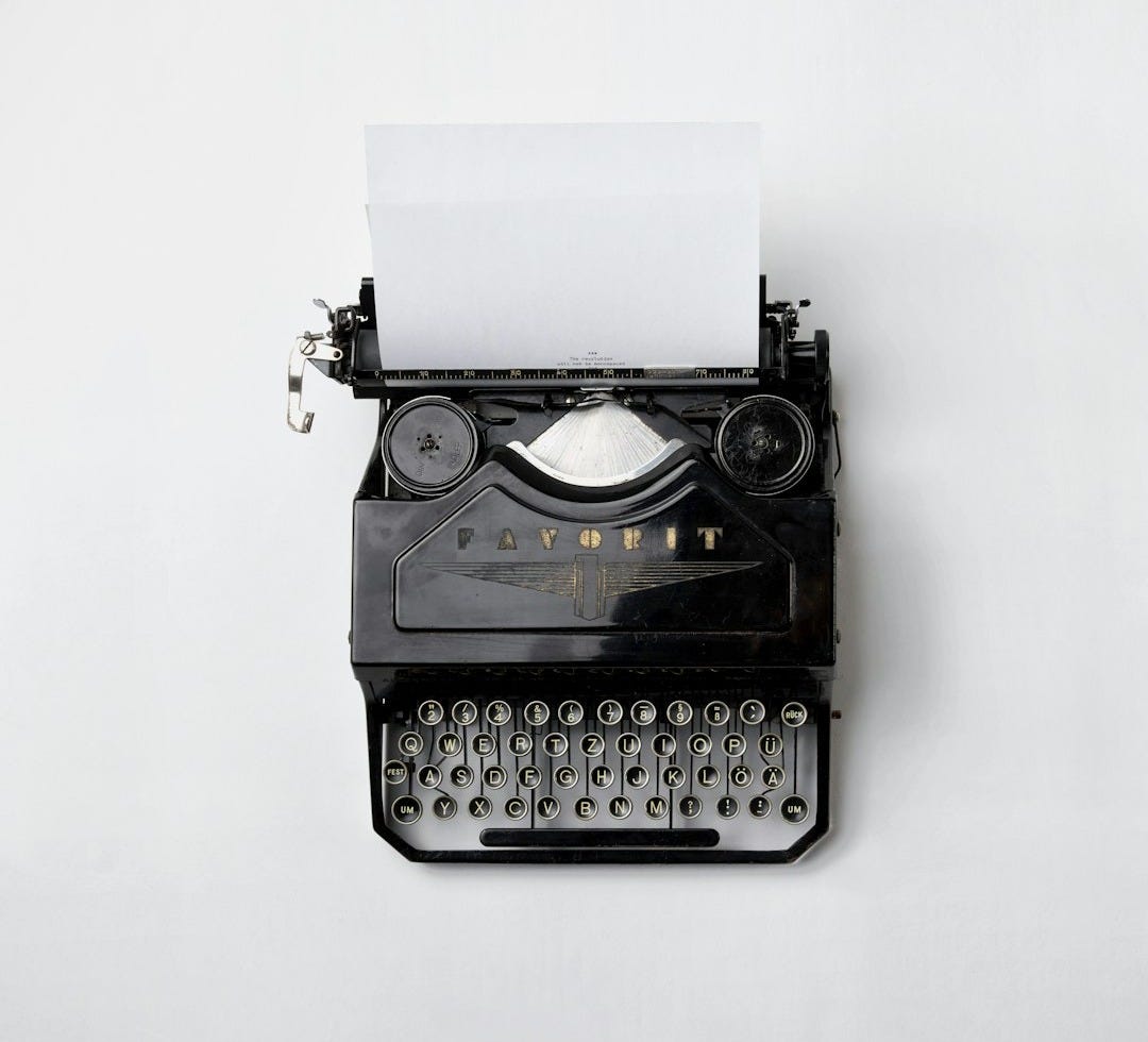 black Fayorit typewriter with printer paper