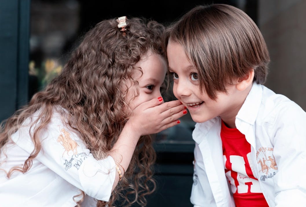 woman in white long sleeve shirt kissing girl in white long sleeve shirt