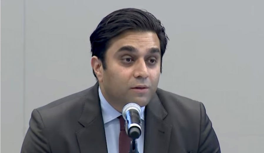 A person in a suit and tie

Description automatically generated with medium confidence