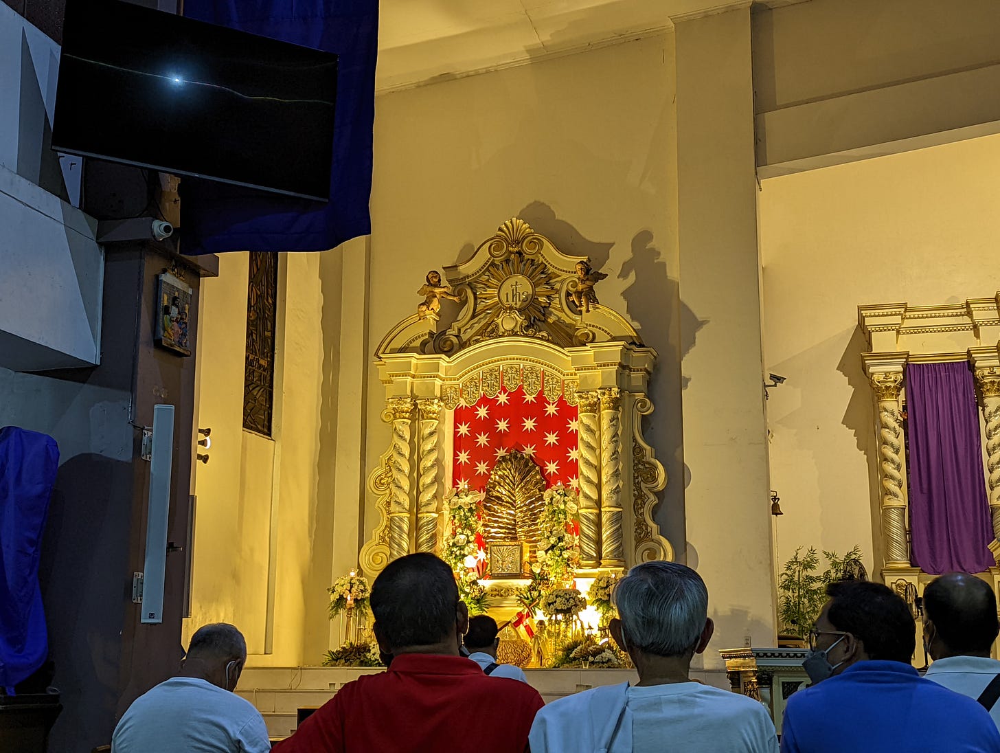 A close up of the altar of repose of the Most Holy Redeemer Church lit by yellow lighting
