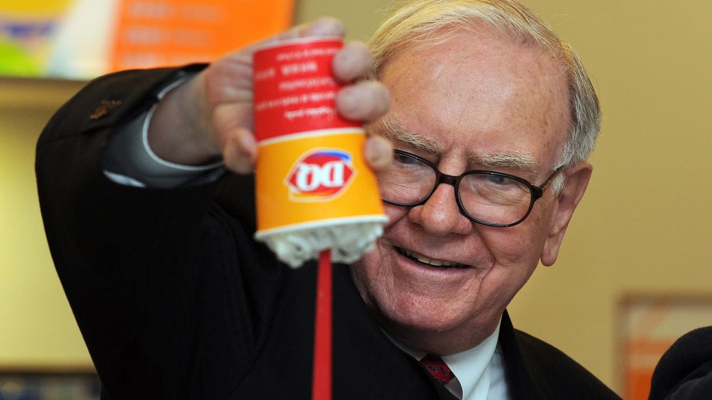 US billionaire investor Warren Buffett flips over a Dairy Queen Blizzard treat, the most successful product ever released in the history of Dairy Queen, a US desert chain with over 300 stores in China, at the opening of a new branch in Beijing on September 30, 2010.