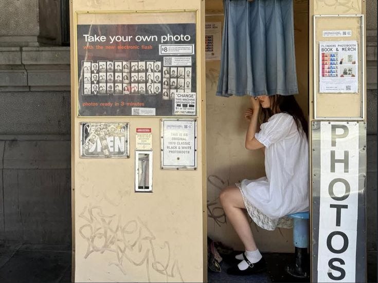 This may contain: a woman is sitting in a small booth