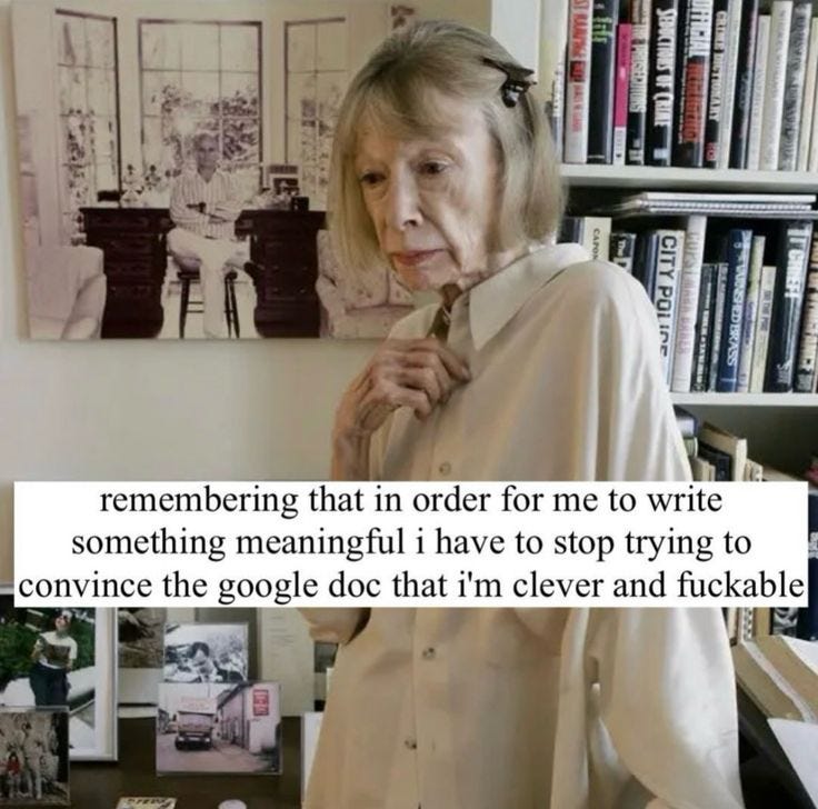 This may contain: an older woman standing in front of a desk with a book shelf and bookshelf behind her