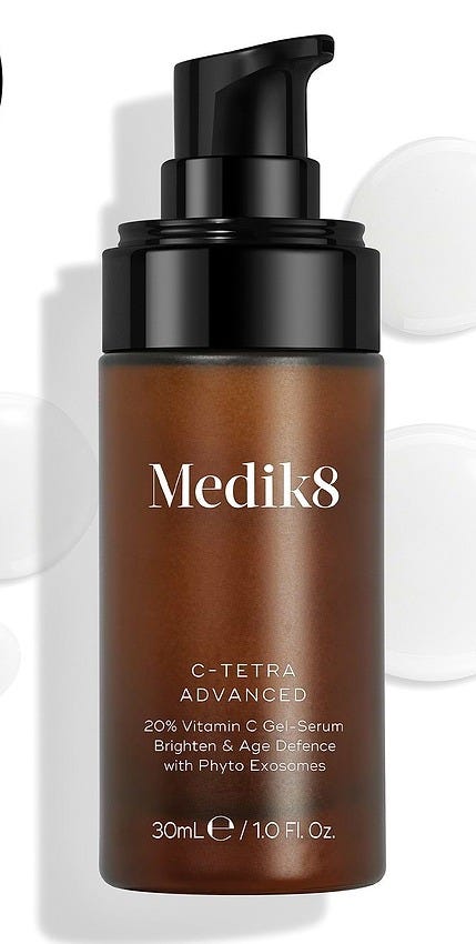 Medik8 C-Tetra Advanced bottle displayed on a clean white background with translucent serum droplets, highlighting its lightweight gel-serum texture.
