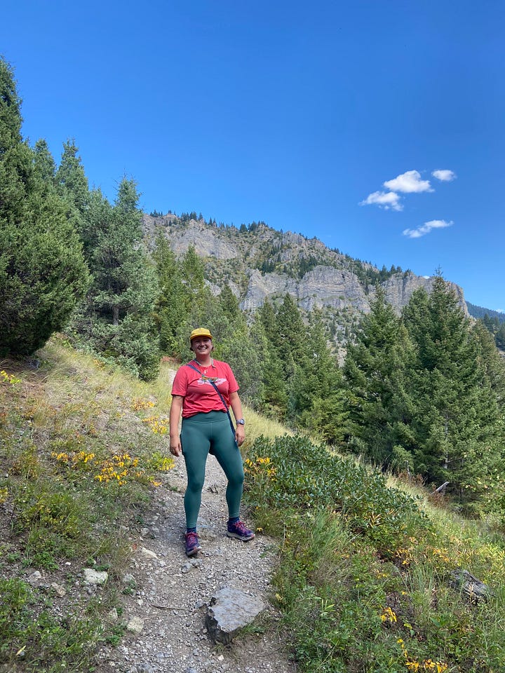 Meg Smith stands on a trail in Montana Mountains on a run.