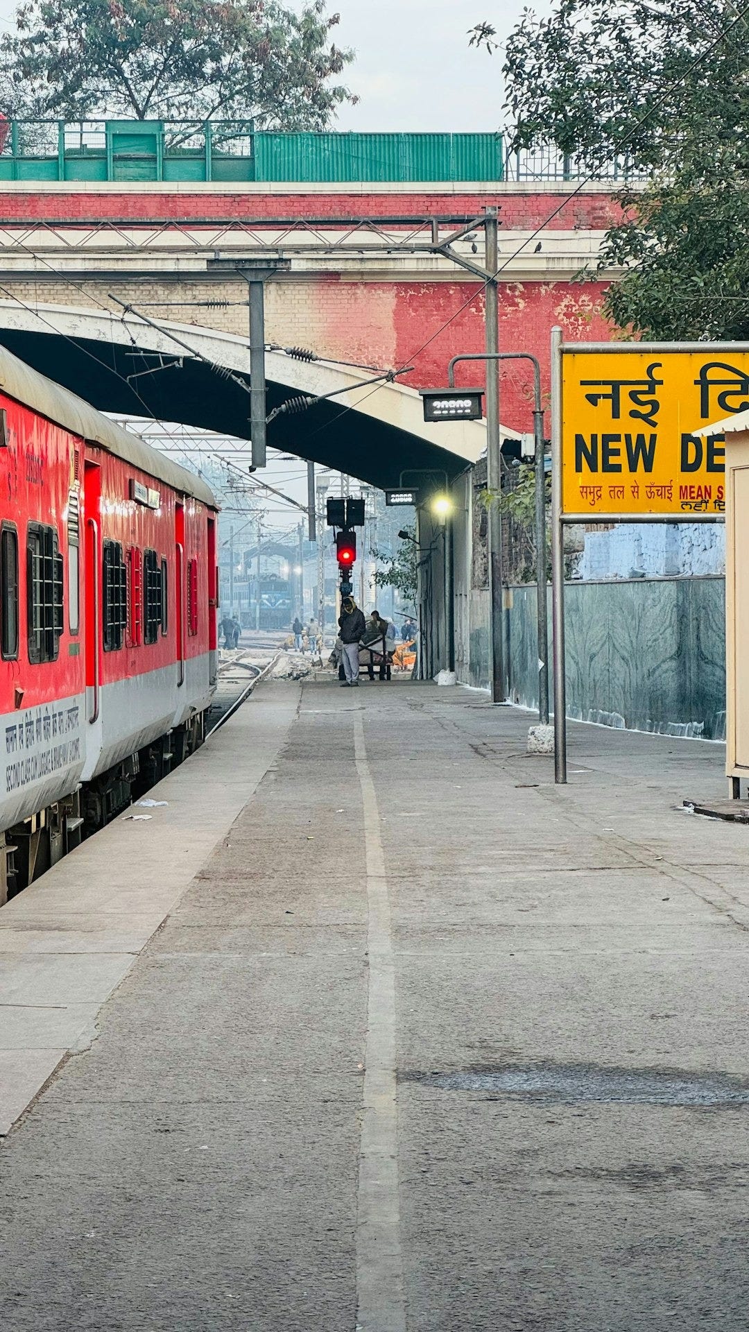 a red train stopped at a train station