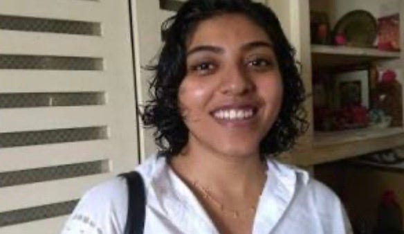 A person smiling at the camera

Description automatically generated