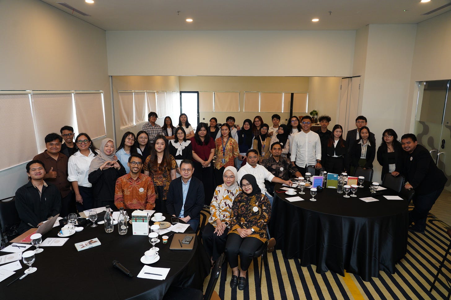 A large group photo of BINUS University faculty, student representatives, invited speakers, and event organizers standing together on stage during the launch of the Korean Peninsula Research Cluster. A large group photo of BINUS University faculty, student representatives, invited speakers, and event organizers standing together on stage during the launch of the Korean Peninsula Research Cluster.