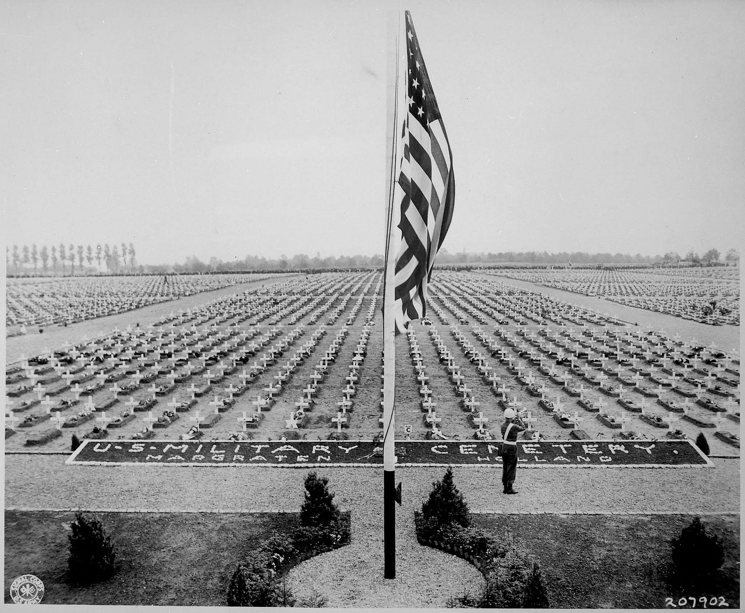 A bugler blows taps at the close of Memorial Day service at Margraten Cemetery, Holland, where lie thousands of American heroes of World War II, 1945. (US Army Signal Corps photo)