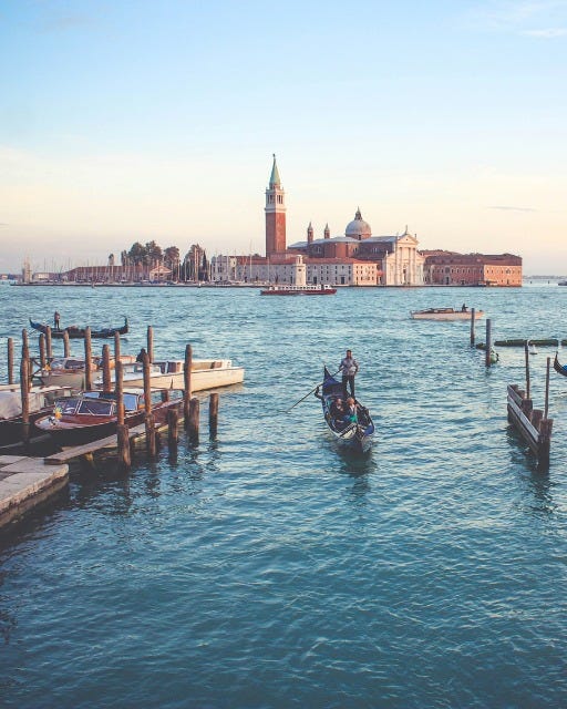 May be an image of 1 person, boat and bell tower
