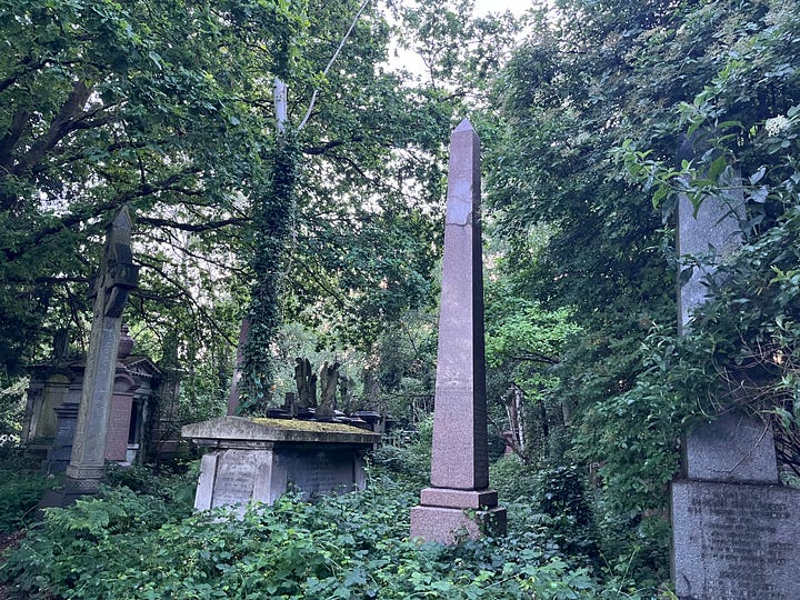 Obelisk grave monuments in an overgrown cemetery