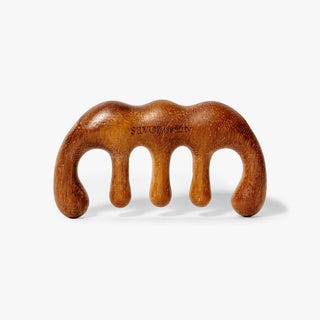 Wooden scalp gua sha on a white background Wooden scalp gua sha on a white background