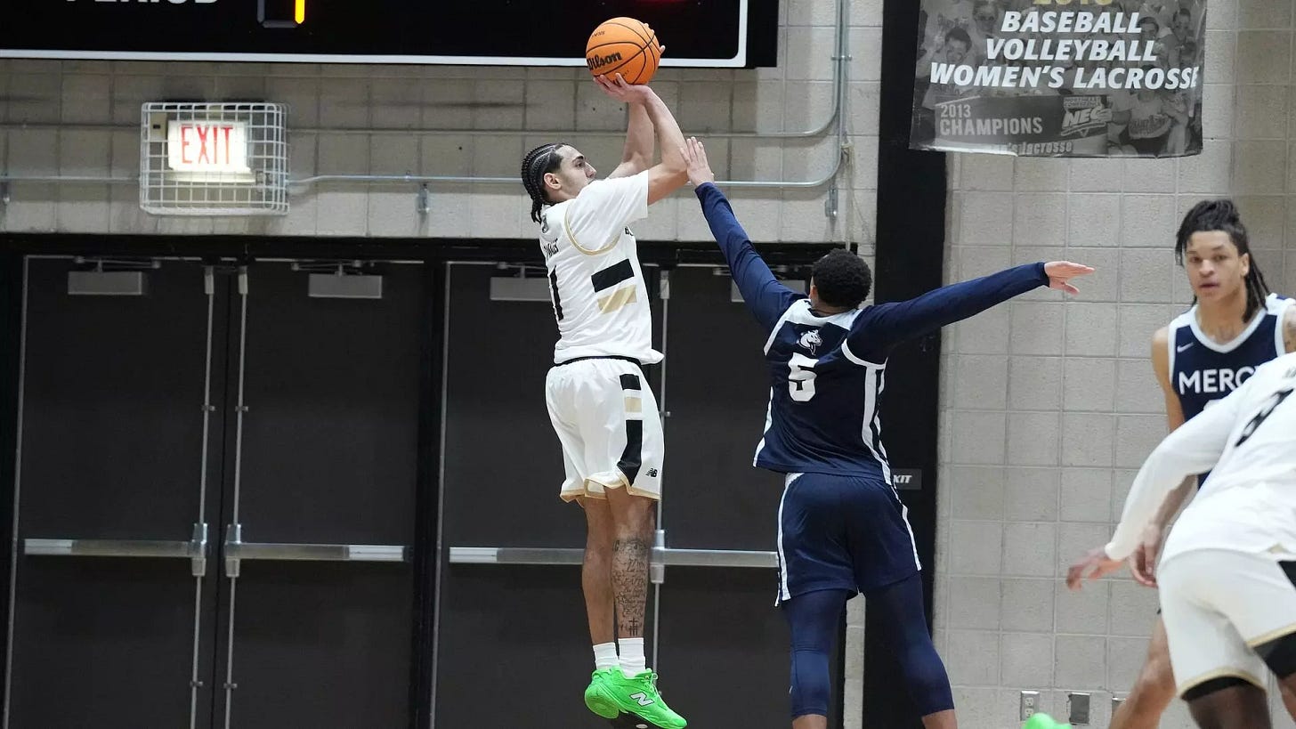 Ty Tabales attempts a three point field goal against Mercy