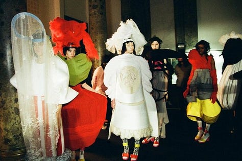 Left to right: Comme des Garçons Fall/Winter 1997 (Body Meets Dress, Dress Meets Body), Spring/Summer 2018 (sculptural florals), and Fall/Winter 2012 (flat form silhouettes), each exemplifying Rei Kawakubo’s ongoing interrogation of volume, distortion, and the limits of fashion as a wearable medium.