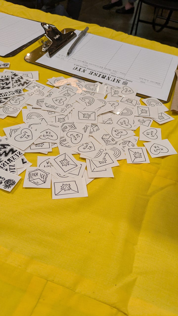 Left: pile of temporary tattoos on a table, Right: Temporary tattoo that says "Fuck AI" on an arm