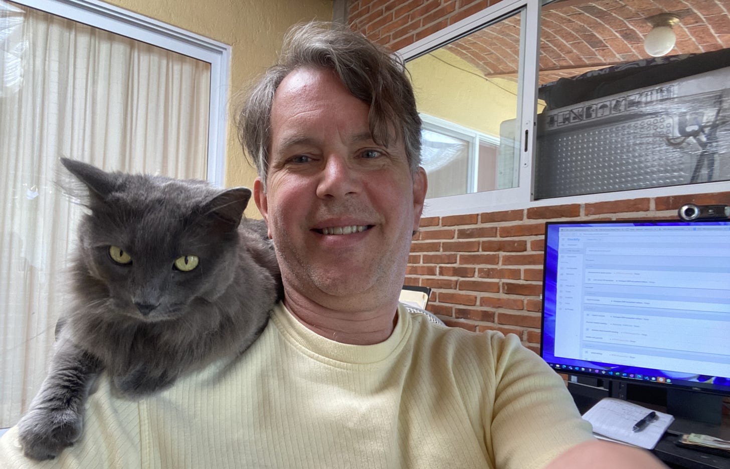 photo of me and my cat gracie with my computer screen in the background.