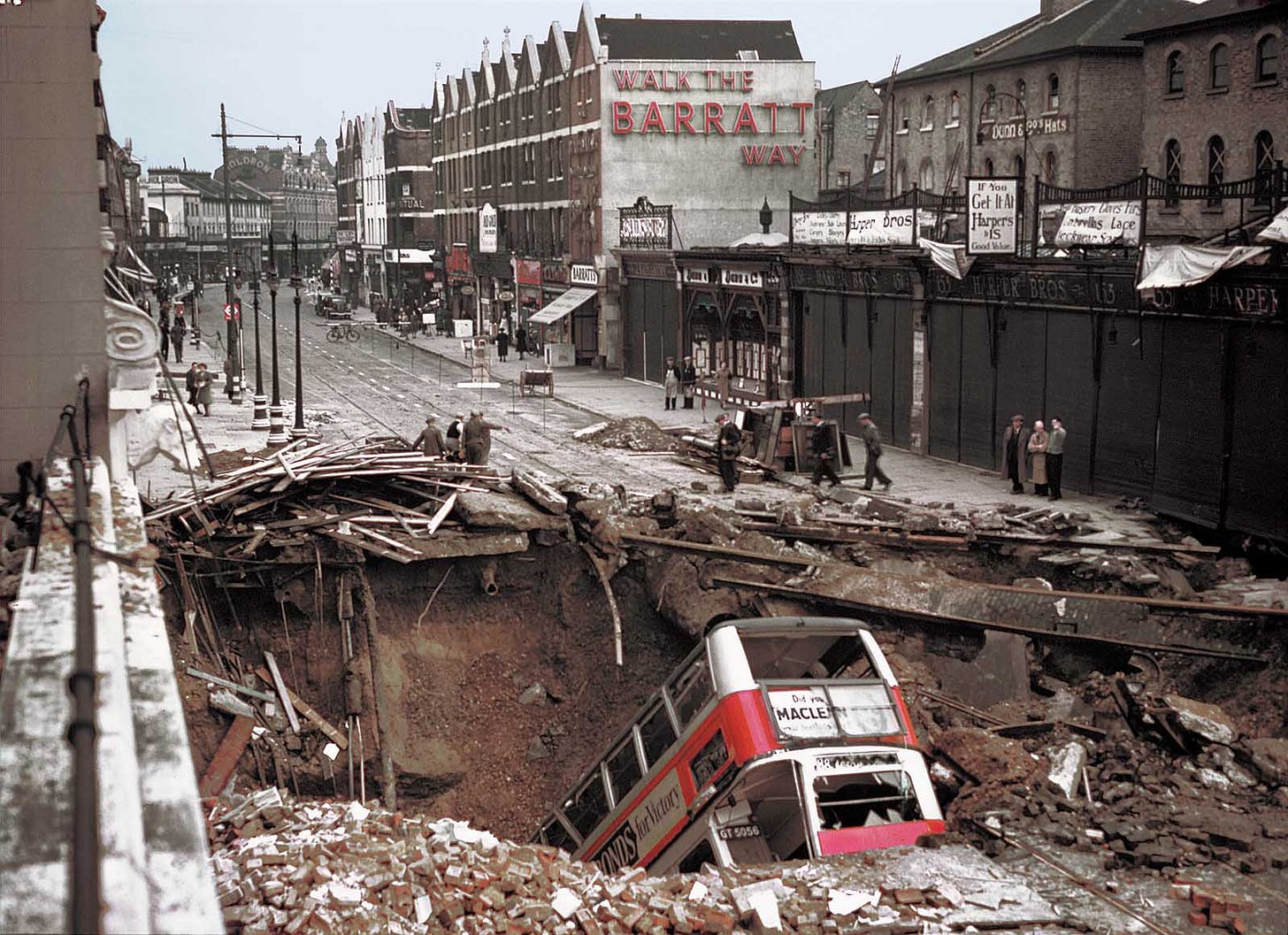 October 14, 1940: A German bomb strikes above Balham Underground Station in London, creating a massive crater that swallowed a double-decker bus and resulted in approximately 66 fatalities.
