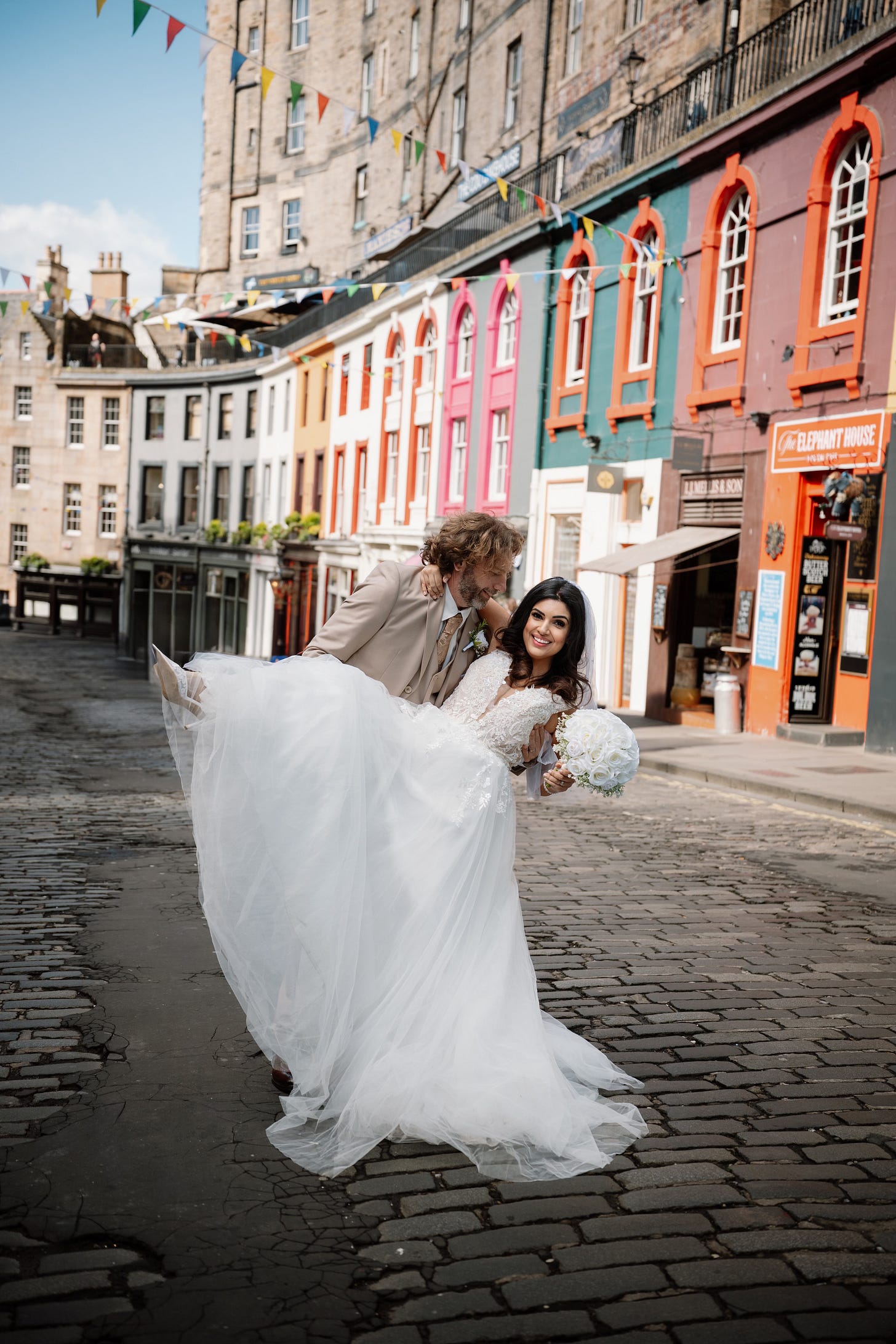 Adam Juniper and Ariane Sherine Juniper on their wedding day in the middle of Edinburgh's colourful George Street