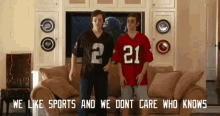 two men in football jerseys with the number 21 on them are standing in a living room . two men in football jerseys with the number 21 on them are standing in a living room .