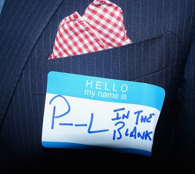 a close up of a person wearing a suit and tie